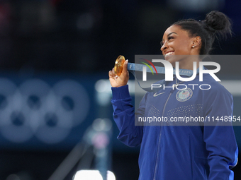 Gold medalist and winner Simone Biles of USA  poses during medal ceremony victory after the women's final all-round competition on day six o...