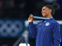 Gold medalist and winner Simone Biles of USA  poses during medal ceremony victory after the women's final all-round competition on day six o...