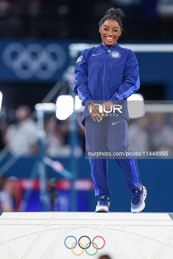 Gold medalist and winner Simone Biles of USA  poses during medal ceremony victory after the women's final all-round competition on day six o...