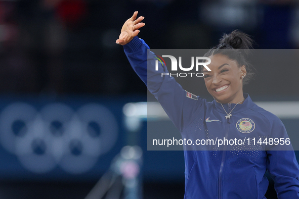 Gold medalist and winner Simone Biles of USA  poses during medal ceremony victory after the women's final all-round competition on day six o...