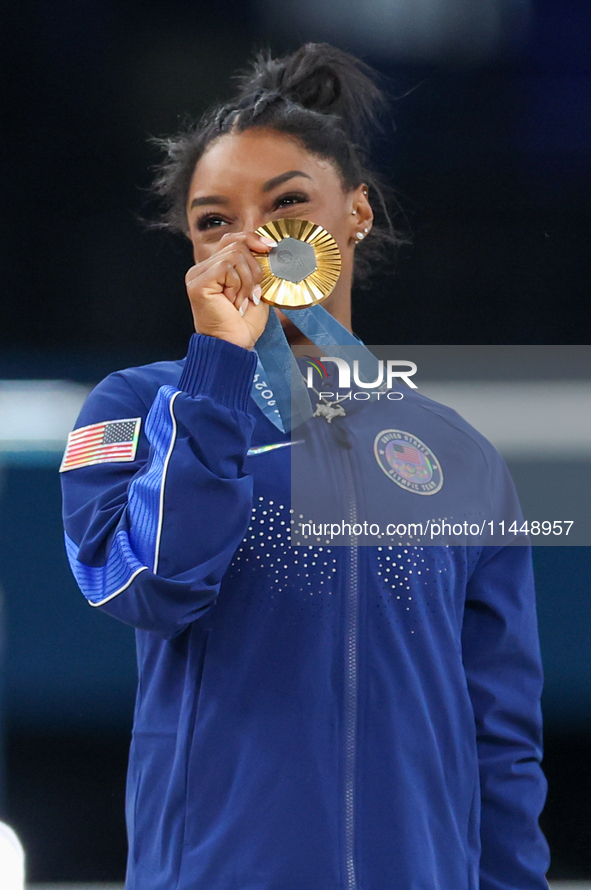 Gold medalist and winner Simone Biles of USA  poses during medal ceremony victory after the women's final all-round competition on day six o...