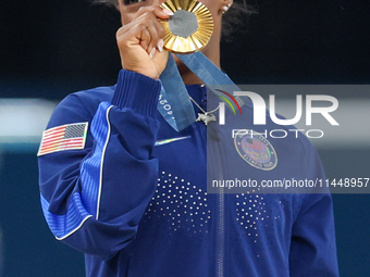 Gold medalist and winner Simone Biles of USA  poses during medal ceremony victory after the women's final all-round competition on day six o...