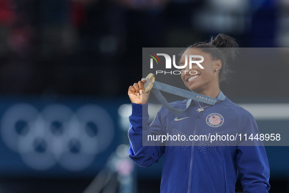 Gold medalist and winner Simone Biles of USA  poses during medal ceremony victory after the women's final all-round competition on day six o...