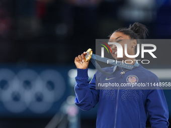 Gold medalist and winner Simone Biles of USA  poses during medal ceremony victory after the women's final all-round competition on day six o...