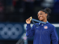 Gold medalist and winner Simone Biles of USA  poses during medal ceremony victory after the women's final all-round competition on day six o...