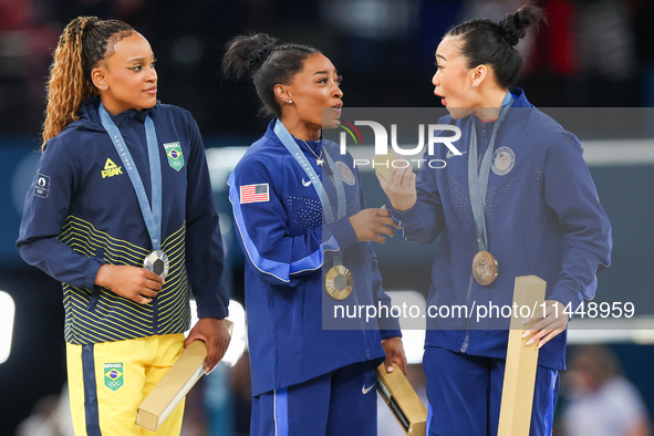 Silver medalist Rebeca Andrade of Team Brazil (L)  Gold medalist and winner Simone Biles (C)  of USA and bronze medalist Suni Lee of USA  ar...