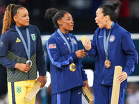 Silver medalist Rebeca Andrade of Team Brazil (L)  Gold medalist and winner Simone Biles (C)  of USA and bronze medalist Suni Lee of USA  ar...