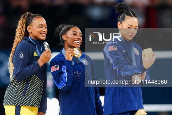 Silver medalist Rebeca Andrade of Team Brazil (L)  Gold medalist and winner Simone Biles (C)  of USA and bronze medalist Suni Lee of USA  ar...