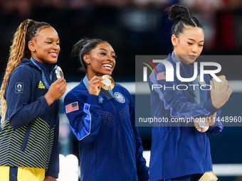 Silver medalist Rebeca Andrade of Team Brazil (L)  Gold medalist and winner Simone Biles (C)  of USA and bronze medalist Suni Lee of USA  ar...