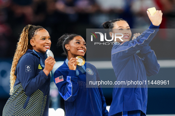 Silver medalist Rebeca Andrade of Team Brazil (L)  Gold medalist and winner Simone Biles (C)  of USA and bronze medalist Suni Lee of USA  ar...