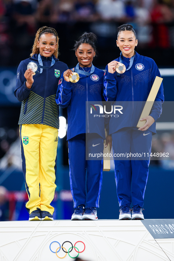 Silver medalist Rebeca Andrade of Team Brazil (L)  Gold medalist and winner Simone Biles (C)  of USA and bronze medalist Suni Lee of USA  ar...