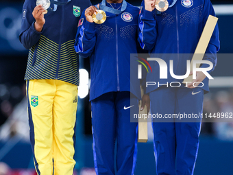 Silver medalist Rebeca Andrade of Team Brazil (L)  Gold medalist and winner Simone Biles (C)  of USA and bronze medalist Suni Lee of USA  ar...