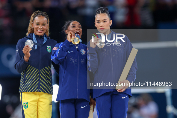 Silver medalist Rebeca Andrade of Team Brazil (L)  Gold medalist and winner Simone Biles (C)  of USA and bronze medalist Suni Lee of USA  ar...