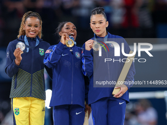 Silver medalist Rebeca Andrade of Team Brazil (L)  Gold medalist and winner Simone Biles (C)  of USA and bronze medalist Suni Lee of USA  ar...