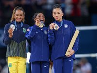 Silver medalist Rebeca Andrade of Team Brazil (L)  Gold medalist and winner Simone Biles (C)  of USA and bronze medalist Suni Lee of USA  ar...