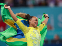 Rebeca Andrade celebrates victory with the Brazilian  flag while the women's final all-round competition on day six of the Olympic Games Par...