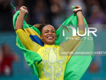 Rebeca Andrade celebrates victory with the Brazilian  flag while the women's final all-round competition on day six of the Olympic Games Par...