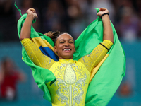 Rebeca Andrade celebrates victory with the Brazilian  flag while the women's final all-round competition on day six of the Olympic Games Par...