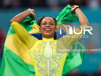 Rebeca Andrade celebrates victory with the Brazilian  flag while the women's final all-round competition on day six of the Olympic Games Par...