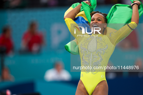 Rebeca Andrade celebrates victory with the Brazilian  flag while the women's final all-round competition on day six of the Olympic Games Par...