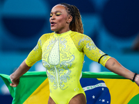 Rebeca Andrade celebrates victory with the Brazilian  flag while the women's final all-round competition on day six of the Olympic Games Par...