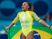 Rebeca Andrade celebrates victory with the Brazilian  flag while the women's final all-round competition on day six of the Olympic Games Par...