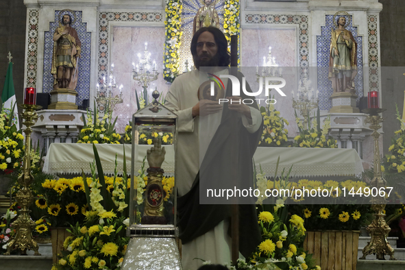 People are viewing an image of Saint Jude Thaddeus at the Church of San Hipolito in Mexico City, Mexico, on August 1, 2024 where dozens of p...