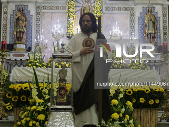 People are viewing an image of Saint Jude Thaddeus at the Church of San Hipolito in Mexico City, Mexico, on August 1, 2024 where dozens of p...