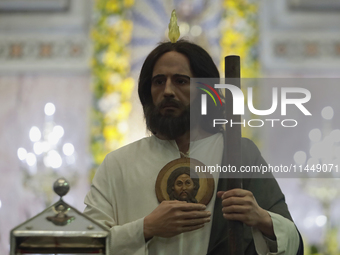 People are viewing an image of Saint Jude Thaddeus at the Church of San Hipolito in Mexico City, Mexico, on August 1, 2024 where dozens of p...