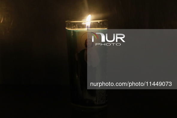 A candle with the image of Saint Jude Thaddeus is being viewed in the Church of San Hipolito in Mexico City, Mexico, on August 1, 2024 where...