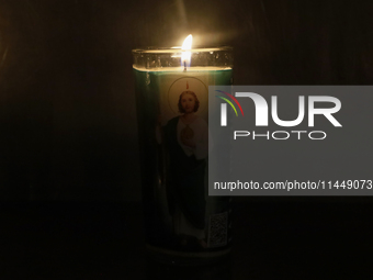 A candle with the image of Saint Jude Thaddeus is being viewed in the Church of San Hipolito in Mexico City, Mexico, on August 1, 2024 where...