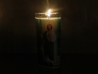 A candle with the image of Saint Jude Thaddeus is being viewed in the Church of San Hipolito in Mexico City, Mexico, on August 1, 2024 where...