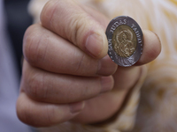 Coins of Saint Jude Thaddeus are being minted outside the Church of San Hipolito in Mexico City, Mexico, on August 1, 2024 where dozens of p...