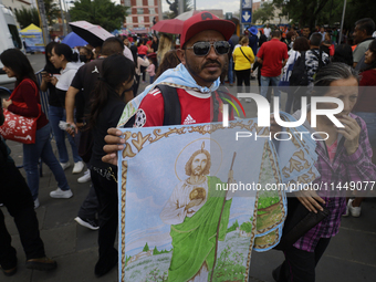 People are selling Saint Jude Thaddeus items outside the Church of San Hipolito in Mexico City, Mexico, on August 1, 2024 where dozens of pe...