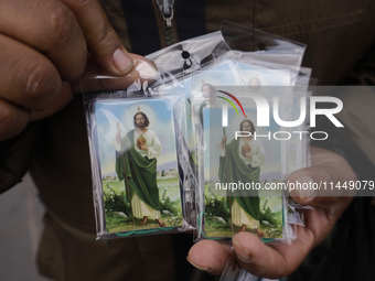 People are selling Saint Jude Thaddeus items outside the Church of San Hipolito in Mexico City, Mexico, on August 1, 2024 where dozens of pe...