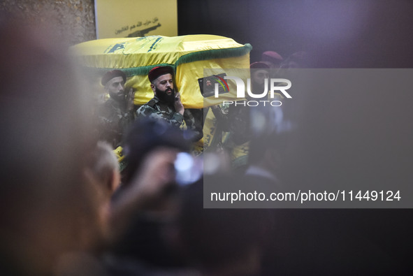 Hezbollah fighters and mourners are attending the funeral ceremony of slain top commander Fuad Shukr in Beirut's southern suburbs, on August...