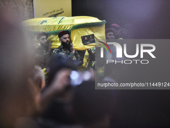 Hezbollah fighters and mourners are attending the funeral ceremony of slain top commander Fuad Shukr in Beirut's southern suburbs, on August...