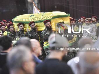 Hezbollah fighters and mourners are attending the funeral ceremony of slain top commander Fuad Shukr in Beirut's southern suburbs, on August...