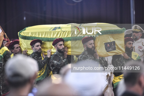 Hezbollah fighters and mourners are attending the funeral ceremony of slain top commander Fuad Shukr in Beirut's southern suburbs, on August...