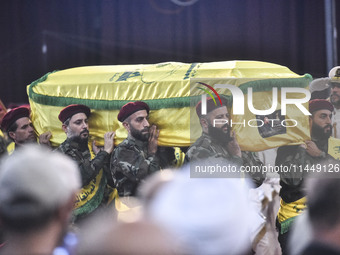 Hezbollah fighters and mourners are attending the funeral ceremony of slain top commander Fuad Shukr in Beirut's southern suburbs, on August...