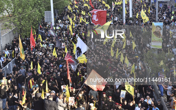 Hezbollah fighters and mourners are attending the funeral ceremony of slain top commander Fuad Shukr in Beirut's southern suburbs, on August...