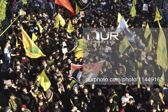 Hezbollah fighters and mourners are attending the funeral ceremony of slain top commander Fuad Shukr in Beirut's southern suburbs, on August...