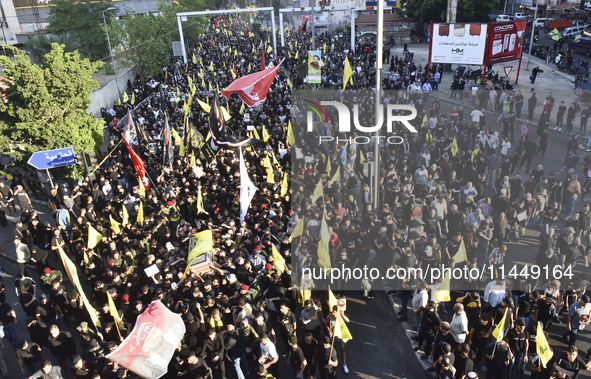 Hezbollah fighters and mourners are attending the funeral ceremony of slain top commander Fuad Shukr in Beirut's southern suburbs, on August...