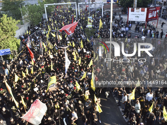 Hezbollah fighters and mourners are attending the funeral ceremony of slain top commander Fuad Shukr in Beirut's southern suburbs, on August...