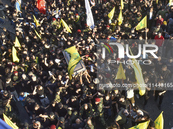 Hezbollah fighters and mourners are attending the funeral ceremony of slain top commander Fuad Shukr in Beirut's southern suburbs, on August...