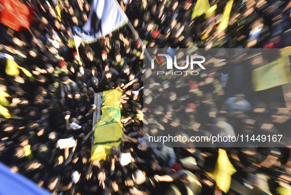 Hezbollah fighters and mourners are attending the funeral ceremony of slain top commander Fuad Shukr in Beirut's southern suburbs, on August...