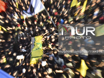 Hezbollah fighters and mourners are attending the funeral ceremony of slain top commander Fuad Shukr in Beirut's southern suburbs, on August...