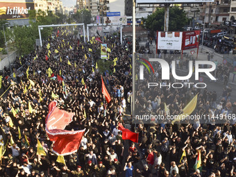 Hezbollah fighters and mourners are attending the funeral ceremony of slain top commander Fuad Shukr in Beirut's southern suburbs, on August...