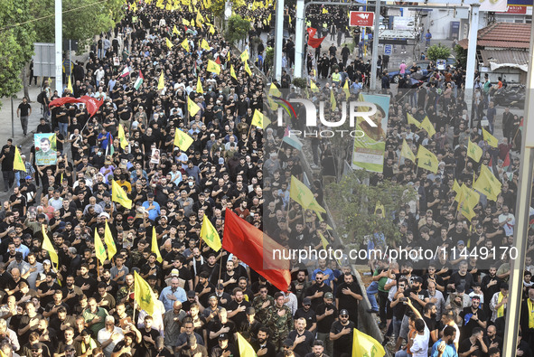 Hezbollah fighters and mourners are attending the funeral ceremony of slain top commander Fuad Shukr in Beirut's southern suburbs, on August...