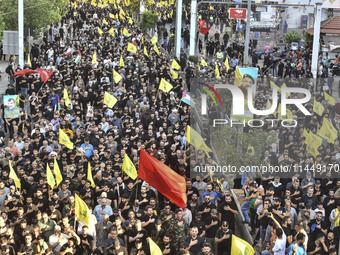 Hezbollah fighters and mourners are attending the funeral ceremony of slain top commander Fuad Shukr in Beirut's southern suburbs, on August...